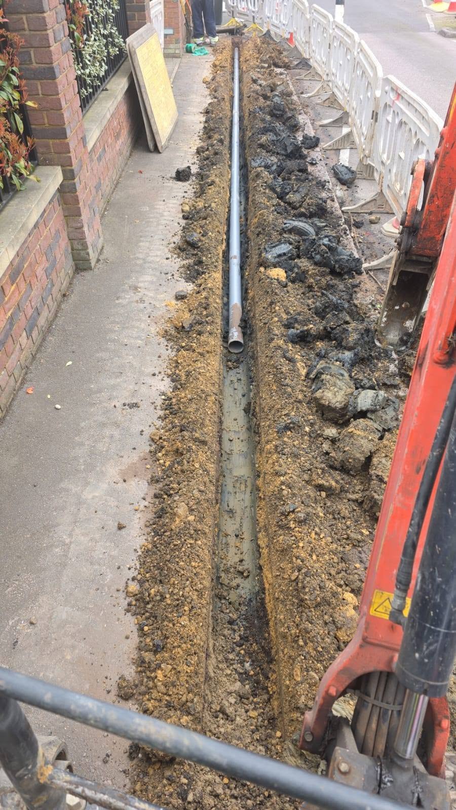 Pipework positioned along an open excavation