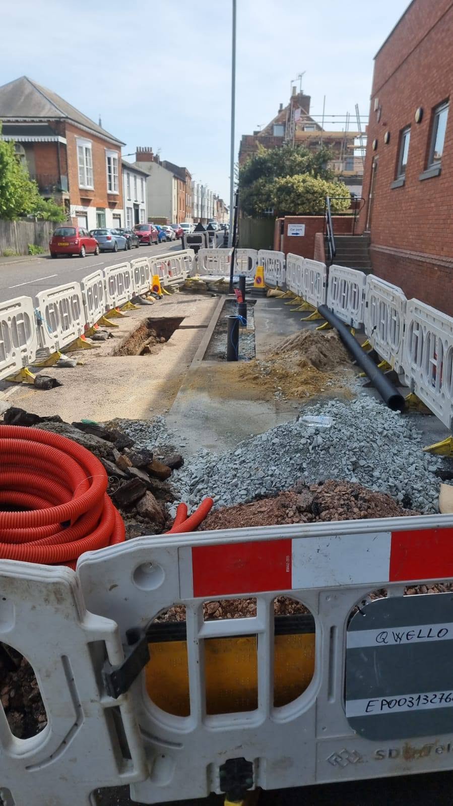 Barrier-protected street-side trenching with utility ducts and pipework