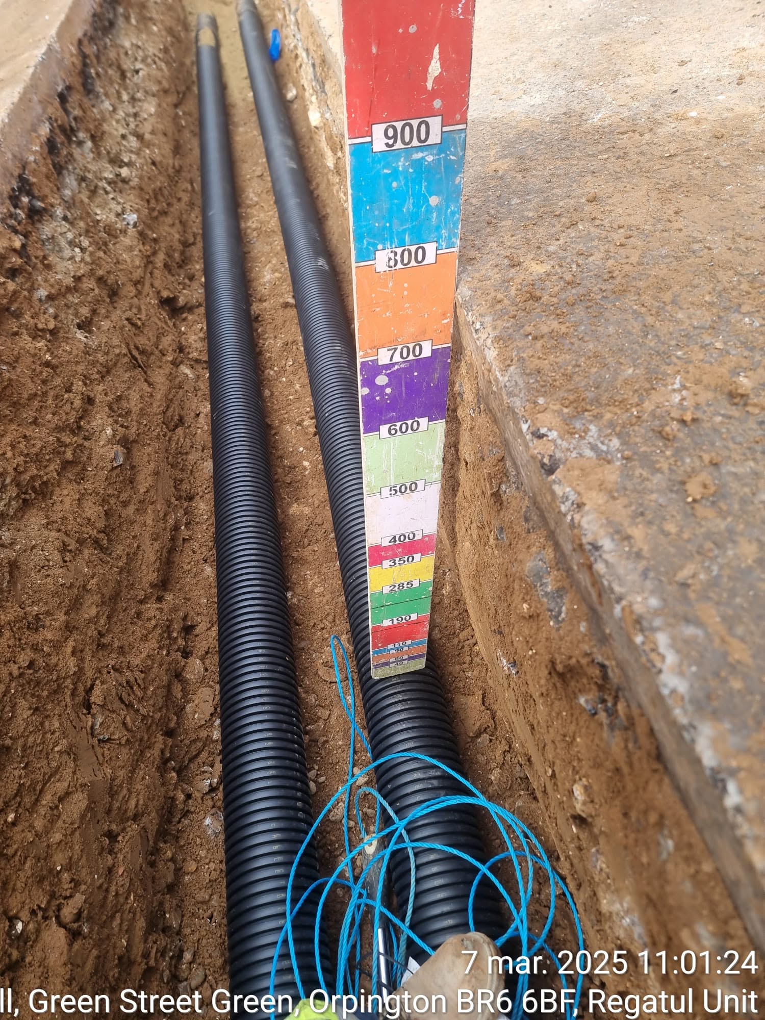 Twin utility ducts laid in an excavated trench